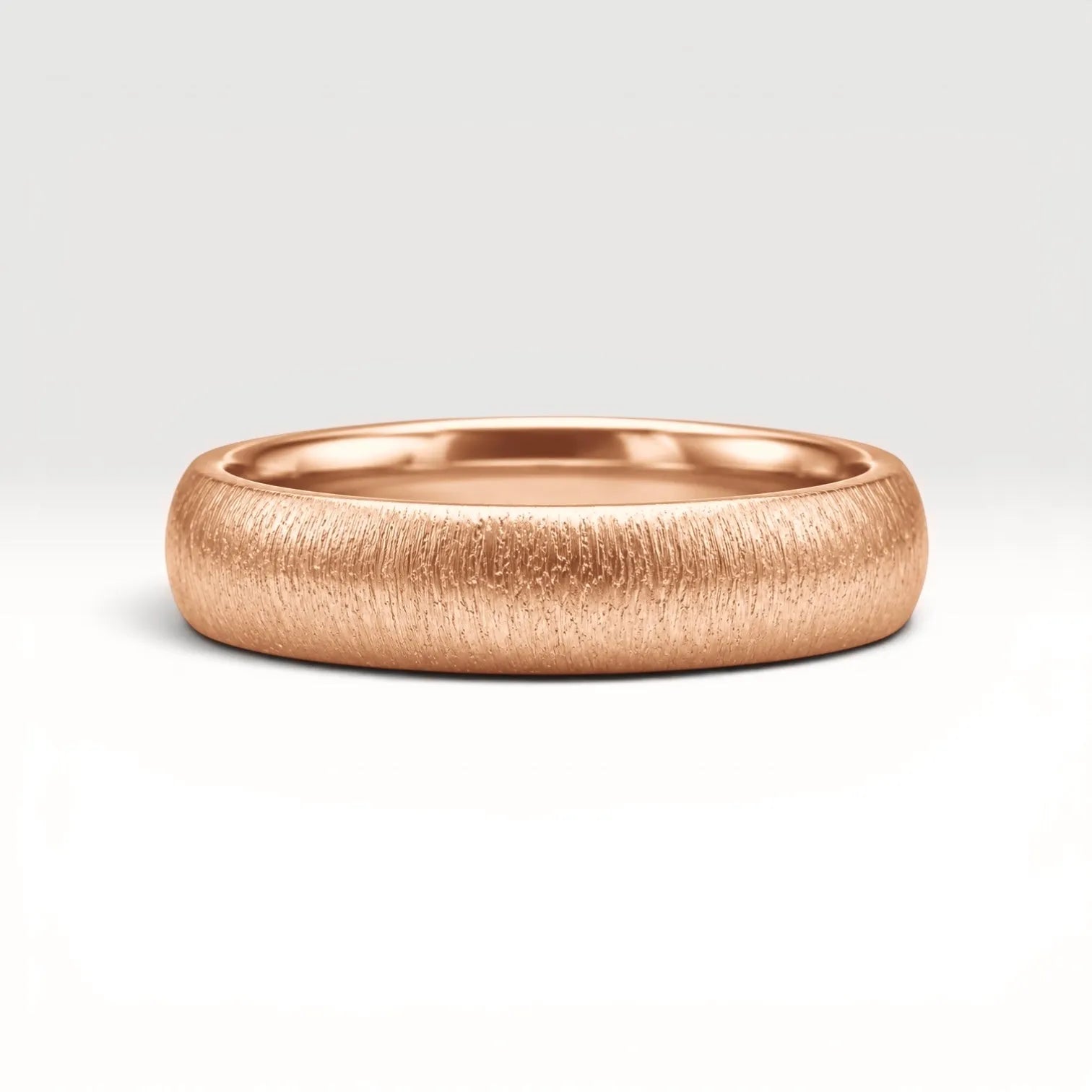 4mm domed rose gold women's wedding band with fine vertical texture creating a luminous sparkle effect