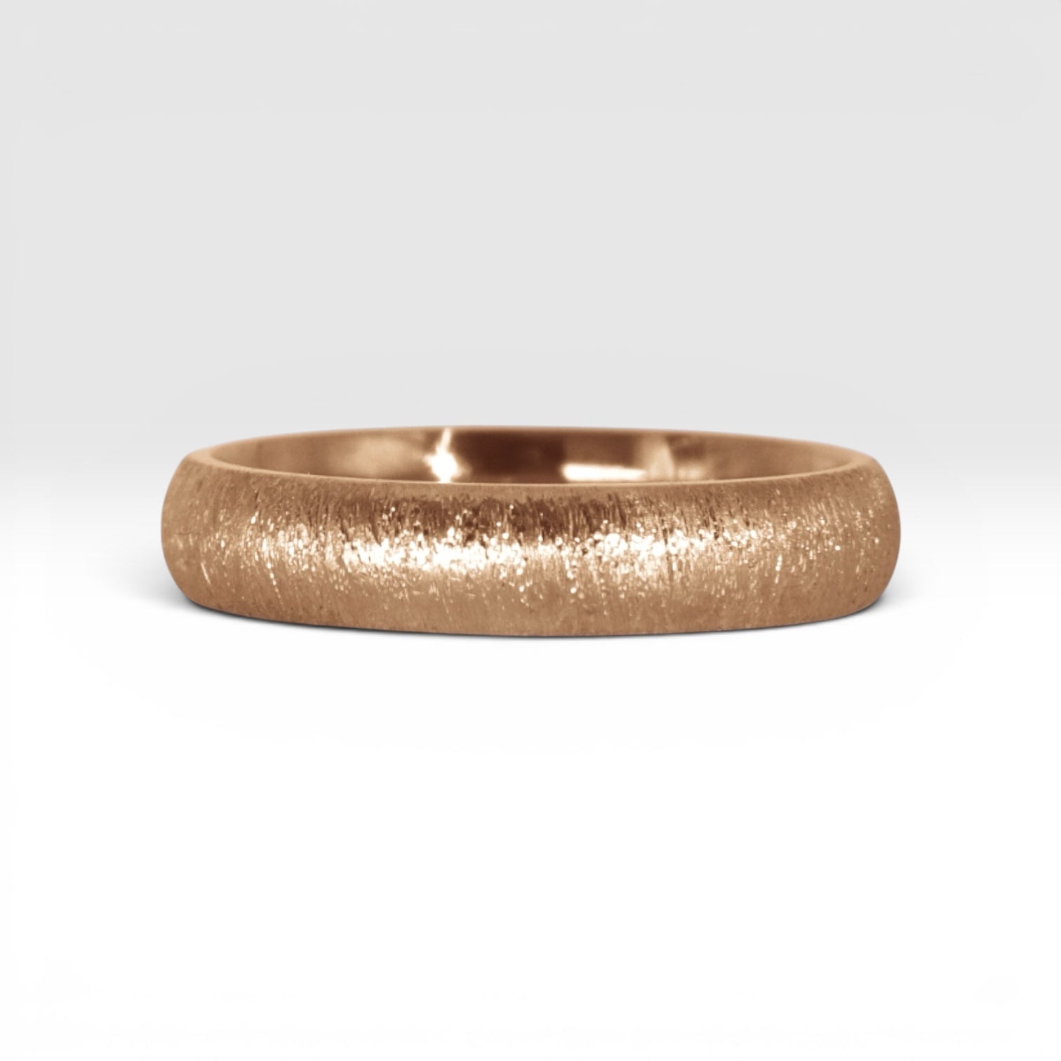4mm domed rose gold women's wedding band with fine vertical texture creating a luminous sparkle effect