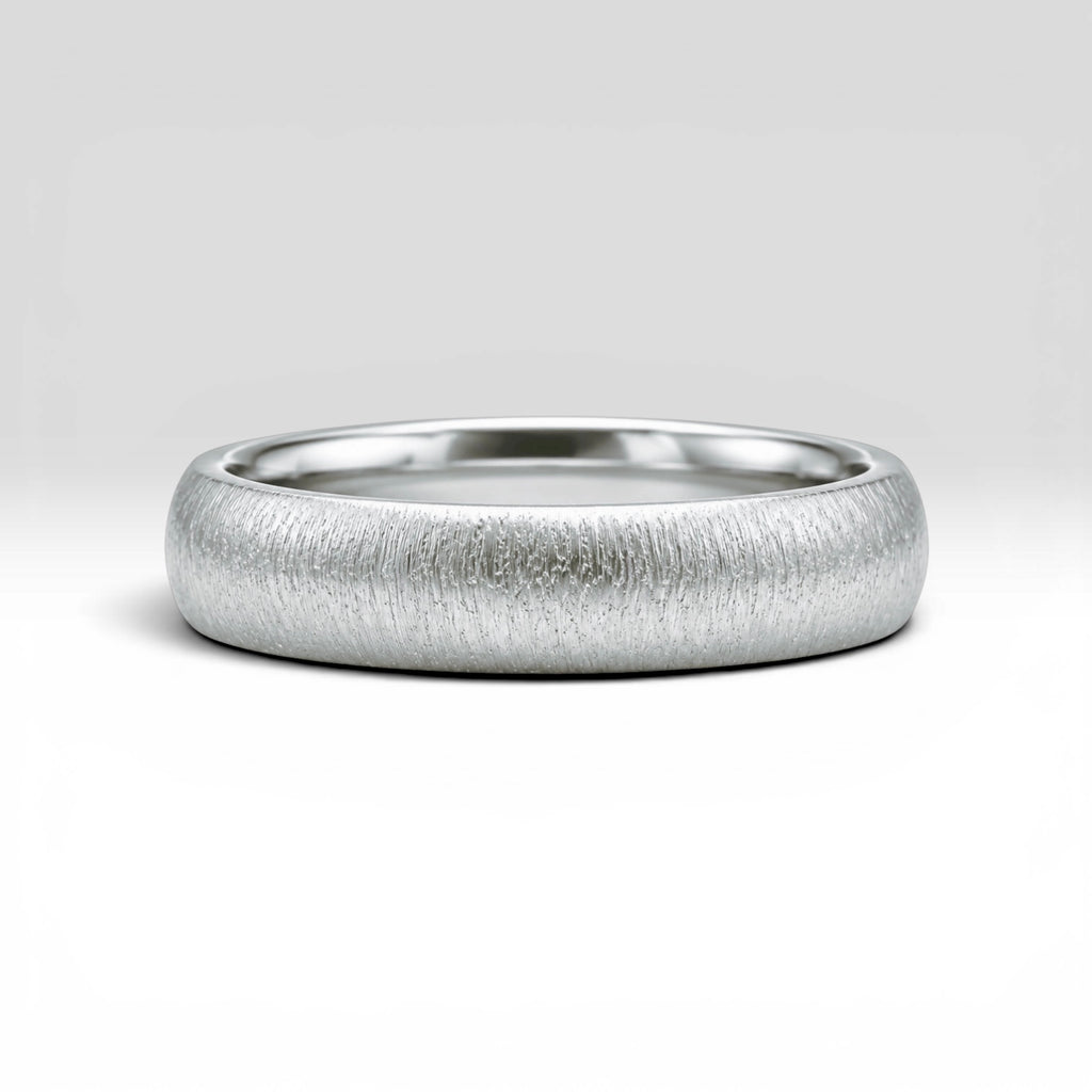 4mm domed sterling silver women's wedding band with fine vertical texture creating a luminous sparkle effect