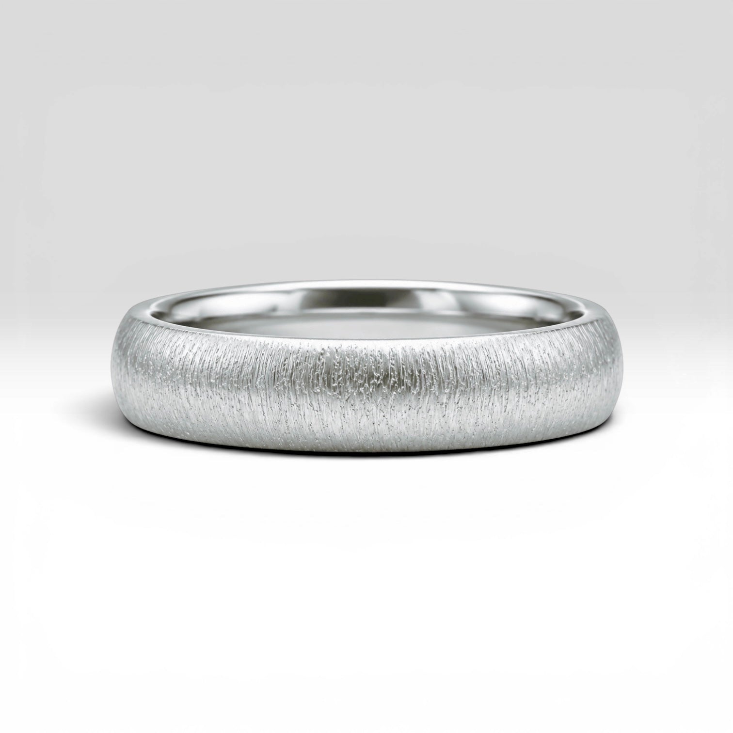 4mm domed sterling silver women's wedding band with fine vertical texture creating a luminous sparkle effect