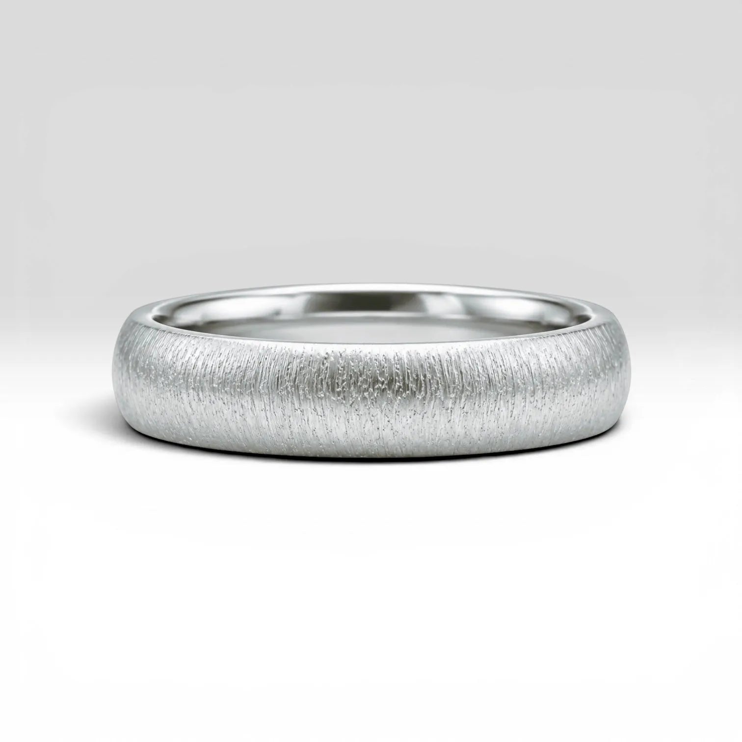 4mm domed sterling silver women's wedding band with fine vertical texture creating a luminous sparkle effect