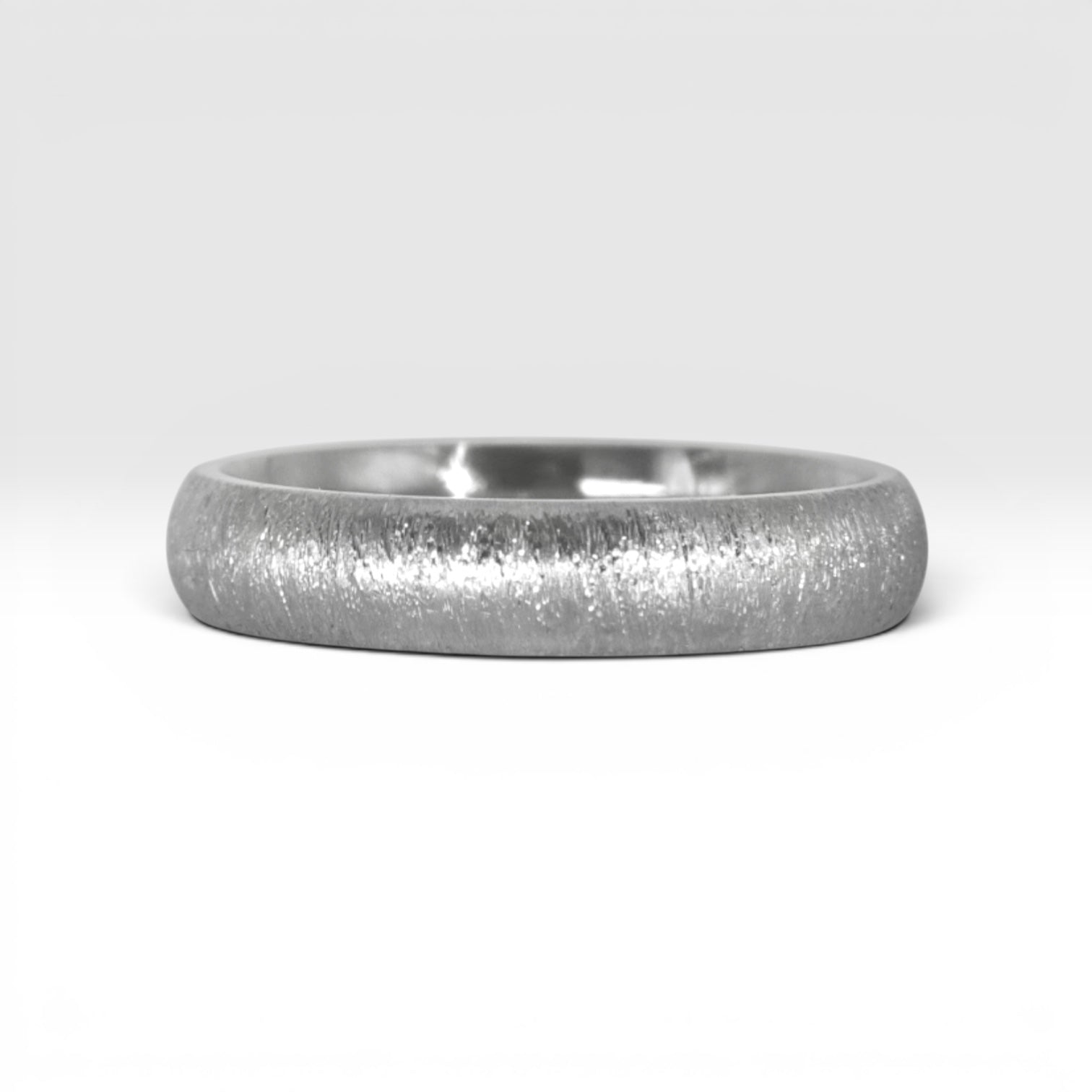 4mm domed sterling silver women's wedding band with fine vertical texture creating a luminous sparkle effect
