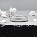4mm domed women's wedding band with fine vertical texture creating a luminous sparkle effect