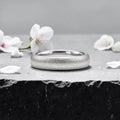 4mm domed women's wedding band with fine vertical texture creating a luminous sparkle effect