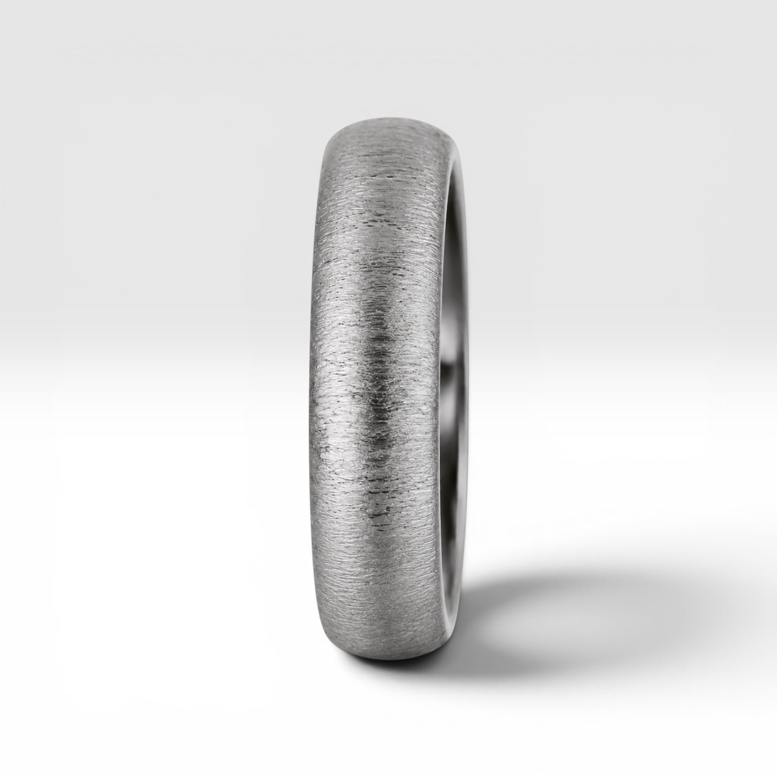 4mm domed women's wedding band with fine vertical texture creating a luminous sparkle effect