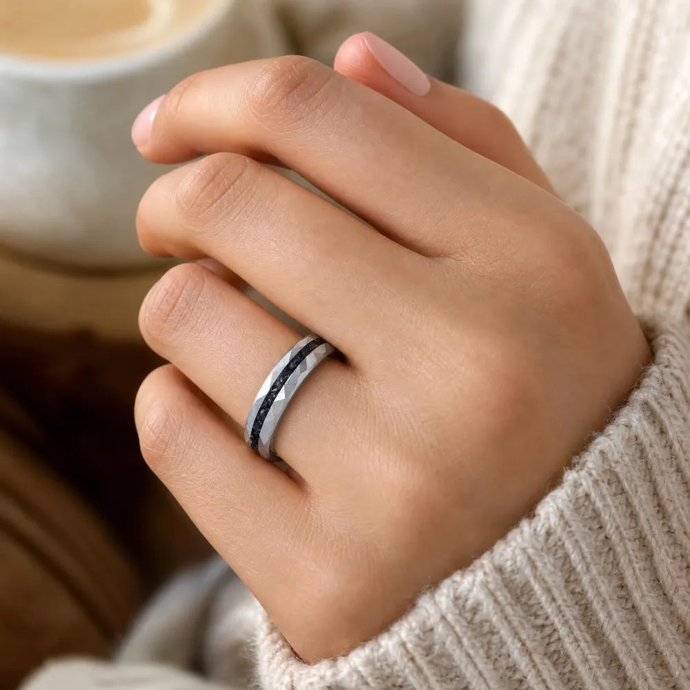 Slim tungsten wedding ring with black tourmaline and gold inlay, faceted finish with refined elegant design