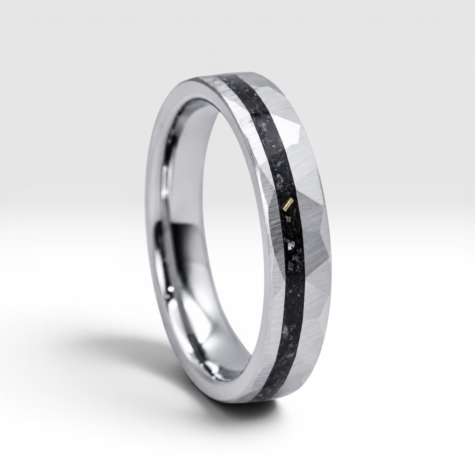Slim tungsten wedding ring with black tourmaline and gold inlay, faceted finish with refined elegant design