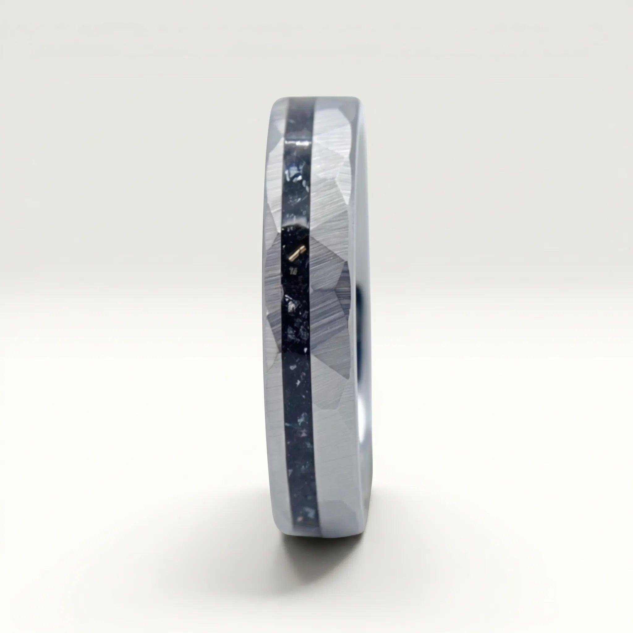 Slim tungsten wedding ring with black tourmaline and gold inlay, faceted finish with refined elegant design
