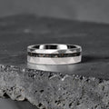Faceted tungsten wedding ring with black tourmaline and 14k gold inlay in a 2mm offset channel