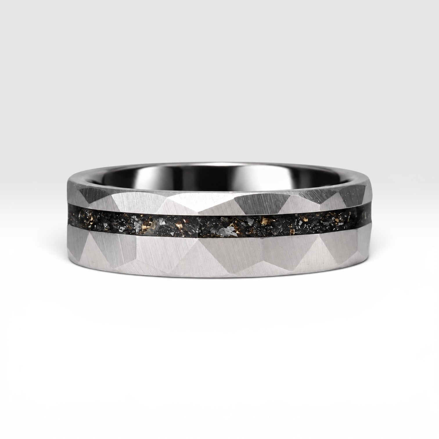 Faceted tungsten wedding ring with black tourmaline and 14k gold inlay in a 2mm offset channel
