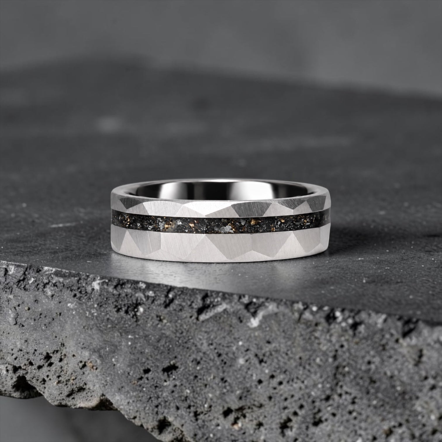 Faceted tungsten wedding ring with black tourmaline and 14k gold shavings inlay in a 2mm offset channel