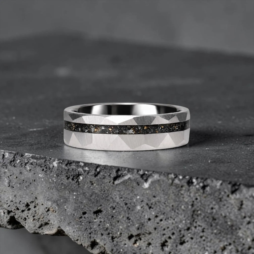 Faceted tungsten wedding ring with black tourmaline and 14k gold shavings inlay in a 2mm offset channel