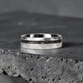 Faceted tungsten wedding ring with black tourmaline and 14k gold shavings inlay in a 2mm offset channel