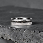 Faceted tungsten wedding ring with black tourmaline and 14k gold shavings inlay in a 2mm offset channel