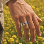 Faceted tungsten wedding ring with black tourmaline and 14k gold shavings inlay in a 2mm offset channel