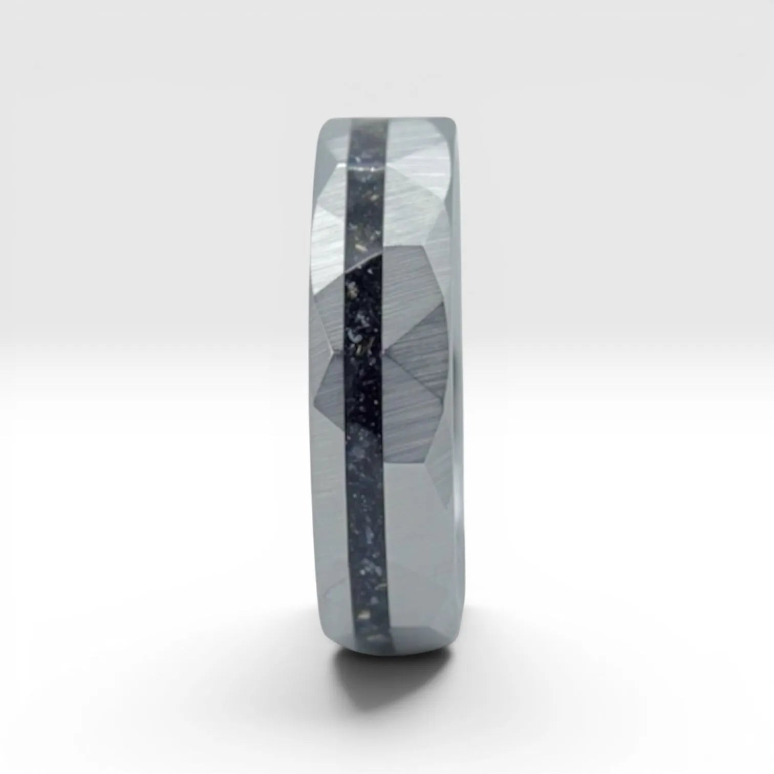Faceted tungsten wedding ring with black tourmaline and 14k gold shavings inlay in a 2mm offset channel