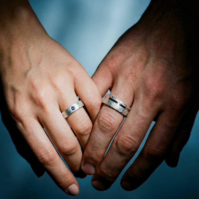 Couple holding hands wearing Aesteria and Asterion wedding bands from Venus Rings collection
