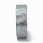 Rustic tungsten band with reclaimed whiskey barrel wood sleeve interior and forged surface finish