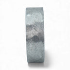 Rustic tungsten band with reclaimed whiskey barrel wood sleeve interior and forged surface finish